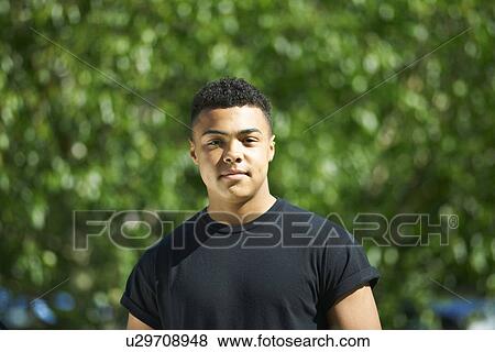 Stock Photo - Portrait of teenage male student outside college. Fotosearch