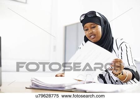 Portrait of young female student in college classroom View Large Photo Image Stock Photography - Portrait of young female student in college classroom. Fotosearch