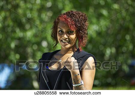 Stock Photo - Portrait of young female student outside college. Fotosearch