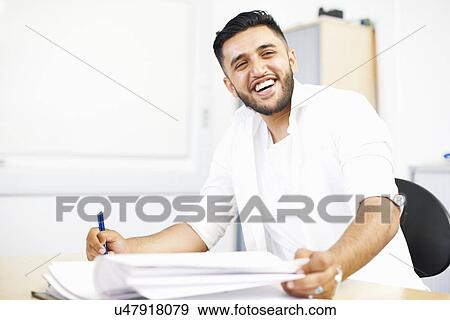 Stock Photo - Portrait of young male student in college classroom. Fotosearch