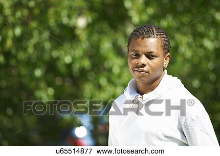 Stock Photo - Portrait of young man outside college. Fotosearch