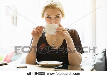 Portrait of young woman drinking coffee View Large Photo Image Stock Image - Portrait of young woman drinking coffee. Fotosearch