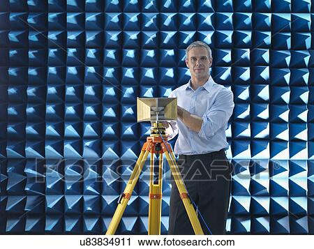 Scientist preparing to measure electromagnetic waves in anechoic chamber, portrait View Large Photo Image Stock Image - Scientist preparing to measure electromagnetic waves in anechoic chamber, portrait. Fotosearch