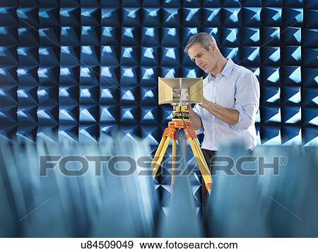 Stock Photo - Scientist preparing to measure electromagnetic waves in anechoic chamber. Fotosearch