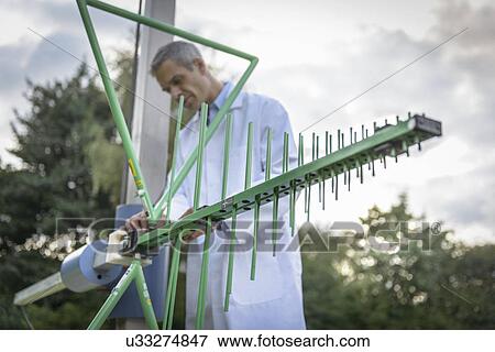 Scientist working outdoors with electromagnetic receiver aerial View Large Photo Image Stock Photo - Scientist working outdoors with electromagnetic receiver aerial. Fotosearch