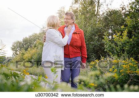 Stock Image - Senior couple in garden. Fotosearch