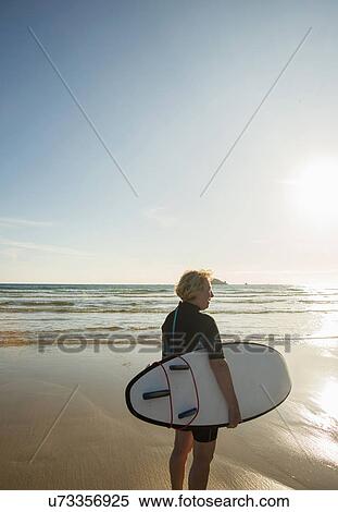 Senior female surfer standing on beach with surfboard, Camaret-sur-mer, Brittany, France View Large Photo Image Stock Photography - Senior female surfer standing on beach with surfboard, Camaret-sur-mer, Brittany, France. Fotosearch