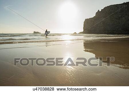 Senior woman walking into sea with surfboard, Camaret-sur-mer, Brittany, France View Large Photo Image Stock Photo - Senior woman walking into sea with surfboard, Camaret-sur-mer, Brittany, France. Fotosearch