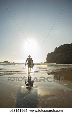 Senior woman walking toward sea with surfboard, Camaret-sur-mer, Brittany, France View Large Photo Image Stock Photography - Senior woman walking toward sea with surfboard, Camaret-sur-mer, Brittany, France. Fotosearch