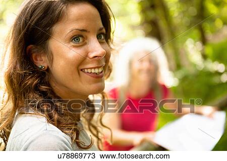 Stock Image - Side view of woman with wide smile. Fotosearch