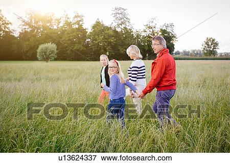 Sisters with grandparents in field View Large Photo Image Stock Photo - Sisters with grandparents in field. Fotosearch