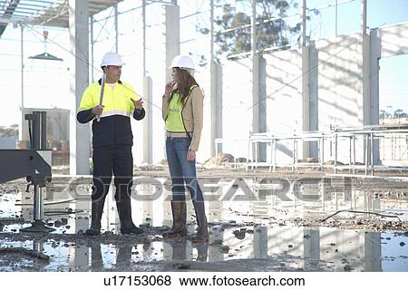 Site manager and architect chatting on construction site View Large Photo Image Stock Photo - Site manager and architect chatting on construction site. Fotosearch