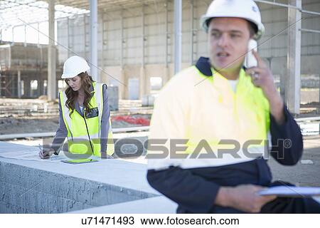 Site manager chatting on smartphone on construction site View Large Photo Image Stock Image - Site manager chatting on smartphone on construction site. Fotosearch