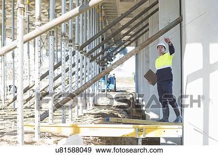 Site manager reaching to checking work on construction site View Large Photo Image Stock Photo - Site manager reaching to checking work on construction site. Fotosearch