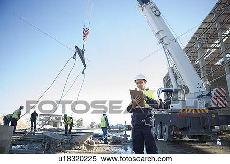 Site manager with clipboard on construction site View Large Photo Image Stock Photography - Site manager with clipboard on construction site. Fotosearch