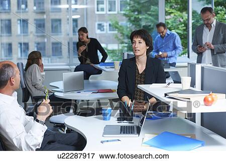 Stock Photo - Six business colleagues working in busy office. Fotosearch