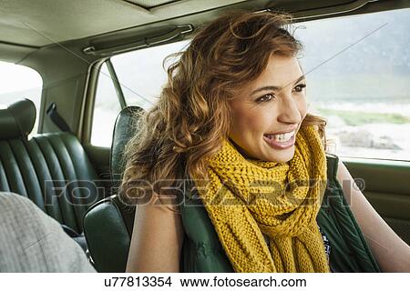 Picture - Smiling young woman in car, Cape Town, Western Cape, South Africa. Fotosearch