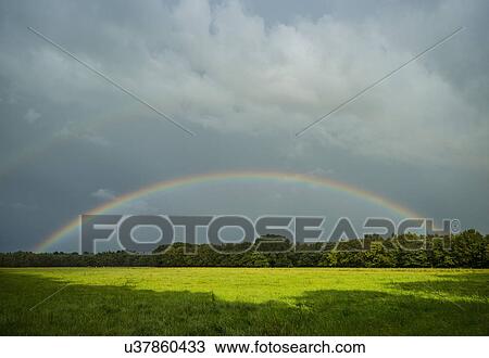 Storm clouds and rainbow over field landscape, Breda, Noord-Brabant, the Netherlands View Large Photo Image Stock Image - Storm clouds and rainbow over field landscape, Breda, Noord-Brabant, the Netherlands. Fotosearch