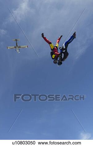 Team of two female skydivers in head down position over Buttwil, Luzern, Switzerland View Large Photo Image Stock Image - Team of two female skydivers in head down position over Buttwil, Luzern, Switzerland. Fotosearch