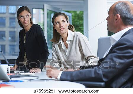 Three business colleagues meeting in office View Large Photo Image Stock Image - Three business colleagues meeting in office. Fotosearch