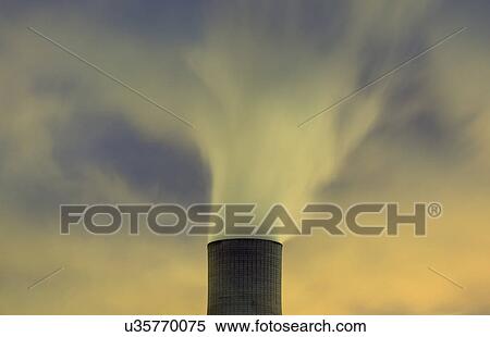 Stock Photography - Top of cooling tower and blurred smoke at night. Fotosearch