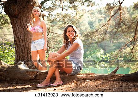 Stock Image - Two female friends at Blue Pool, Wareham, Dorset, UK. Fotosearch