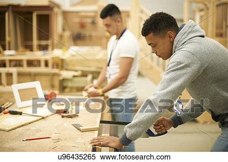 Two male college students in woodworking workshop View Large Photo Image Stock Photography - Two male college students in woodworking workshop. Fotosearch