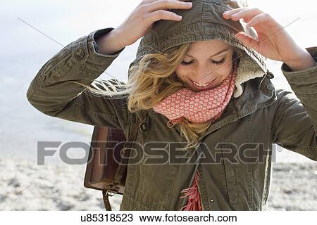 Woman all wrapped up on windy beach View Large Photo Image Stock Image - Woman all wrapped up on windy beach. Fotosearch