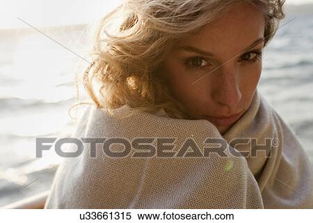 Woman all wrapped up on windy beach View Large Photo Image Stock Photography - Woman all wrapped up on windy beach. Fotosearch