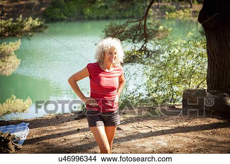Picture - Woman by the Blue Pool, Wareham, Dorset, United Kingdom. Fotosearch