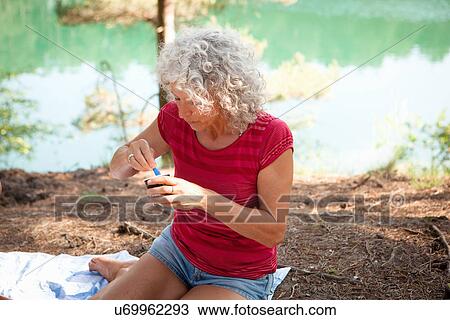Woman by the Blue Pool, Wareham, Dorset, United Kingdom View Large Photo Image Stock Image - Woman by the Blue Pool, Wareham, Dorset, United Kingdom. Fotosearch