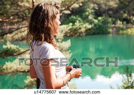 Stock Photo - Woman by the Blue Pool, Wareham, Dorset, United Kingdom. Fotosearch