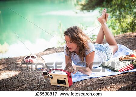 Stock Photo - Woman by the Blue Pool, Wareham, Dorset, United Kingdom. Fotosearch