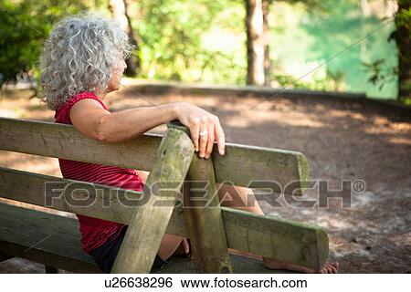 Stock Photograph - Woman by the Blue Pool, Wareham, Dorset, United Kingdom. Fotosearch