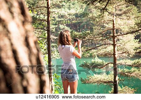 Stock Photography - Woman by the Blue Pool, Wareham, Dorset, United Kingdom. Fotosearch