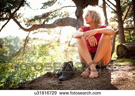 Stock Photo - Woman enjoying nature, The Blue Pool, Wareham, Dorset, United Kingdom. Fotosearch