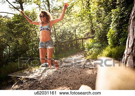 Woman jumping in mid air, The Blue Pool, Wareham, Dorset, United Kingdom View Large Photo Image Stock Image - Woman jumping in mid air, The Blue Pool, Wareham, Dorset, United Kingdom. Fotosearch