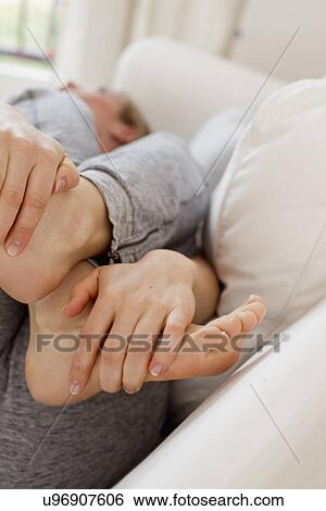 Woman lying on sofa day-dreaming View Large Photo Image Stock Photograph - Woman lying on sofa day-dreaming. Fotosearch