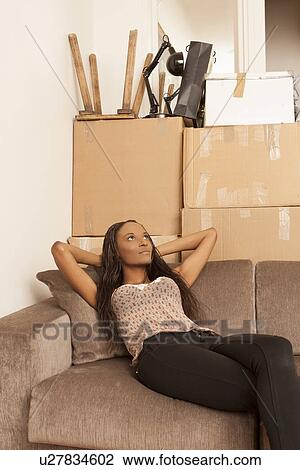Woman sitting in flat surrounded by boxes View Large Photo Image Stock Image - Woman sitting in flat surrounded by boxes. Fotosearch