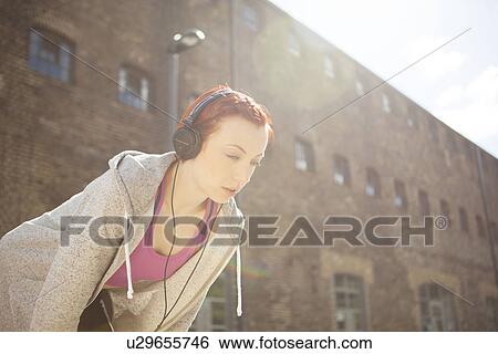 Stock Photograph - Woman taking break at exercise. Fotosearch