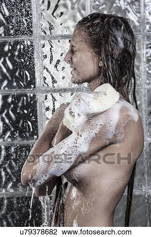 Stock Image - Woman taking shower. Fotosearch