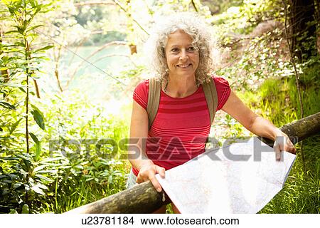 Picture - Woman with map, The Blue Pool, Wareham, Dorset, United Kingdom. Fotosearch