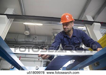 Stock Photo - Worker in industrial plant. Fotosearch