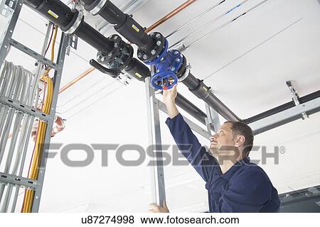 Stock Photo - Worker in industrial plant. Fotosearch