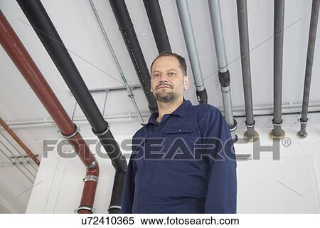 Stock Photography - Worker in industrial plant. Fotosearch