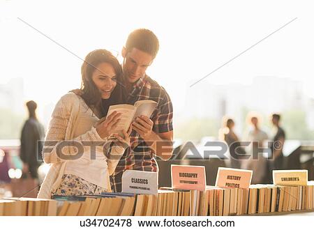 Young couple at second hand book stall View Large Photo Image Stock Photo - Young couple at second hand book stall. Fotosearch