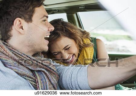 Young couple driving car laughing, Cape Town, Western Cape, South Africa View Large Photo Image Stock Photograph - Young couple driving car laughing, Cape Town, Western Cape, South Africa. Fotosearch