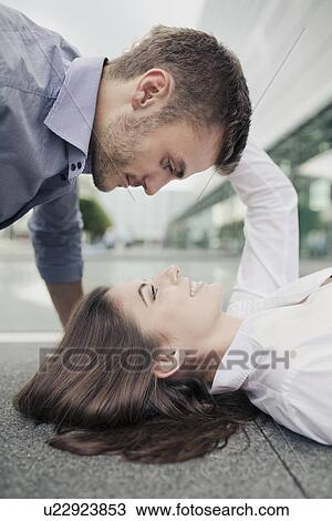 Young couple face to face, woman lying on floor View Large Photo Image Stock Image - Young couple face to face, woman lying on floor. Fotosearch