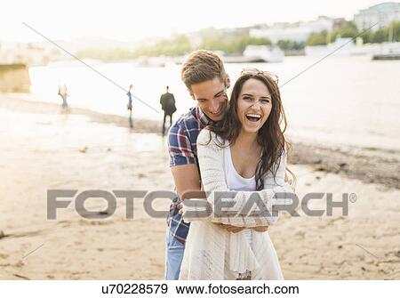 Young couple hugging by river View Large Photo Image Stock Photo - Young couple hugging by river. Fotosearch