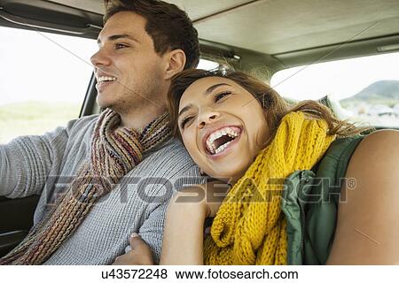 Young couple laughing whilst driving, Cape Town, Western Cape, South Africa View Large Photo Image Stock Photo - Young couple laughing whilst driving, Cape Town, Western Cape, South Africa. Fotosearch